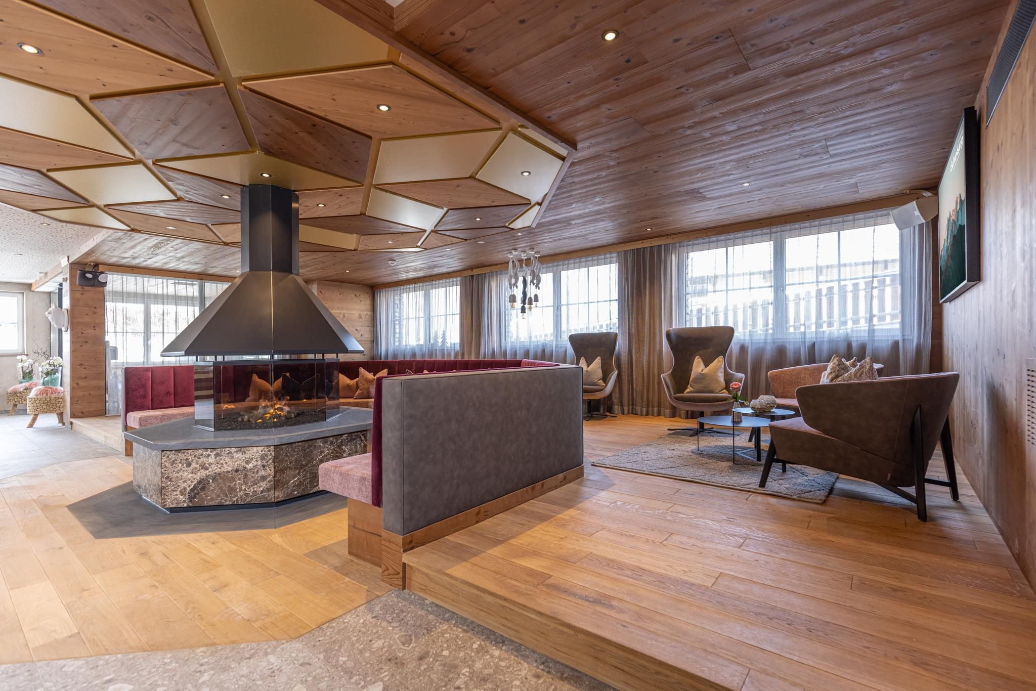 A modern living space with a stylish fireplace as the centerpiece. The decor is cozy and invites relaxation.